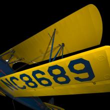 Yellow painted wings of an aircraft. NC8680 is painted on the wings on the aircraft. 