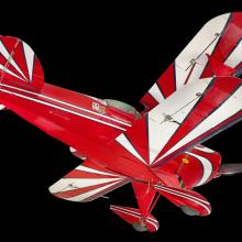 View of the undercarriage of a red, white, and blue painted aerobatic biplane. 