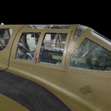 Close up view of a cockpit of a green painted jet aircraft. 