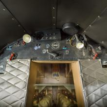 View of a instrument panel leading to the cabin of the plane. 