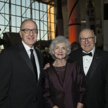 Smithsonian Secretary Dr. David Skorton, a white male, stands on the left of Mrs. Marilyn Lovell, an older white woman, and 2016 National Air and Space Museum Lifetime Achievement Award winner James Lovel, an older white man.