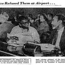 Newspaper clipping with black and white photo of two men sitting at a food counter. 