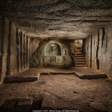 A trench with art carved into wall by artist soldiers.