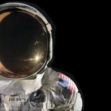 On the left side of the image, a crisp white spacesuit and helmet contrasts with the black background.