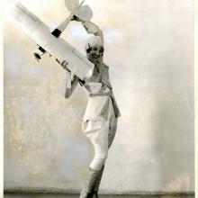 Woman posing with a model aircraft.