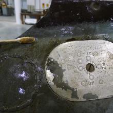 A section of the Horten Ho 229 V3 has had stains partially removed so that it resumes its original color.