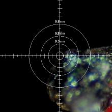 Analysis to determine the chemical makeup of a particle found in adhesive of a World War II era aircraft. The analysis has a crosshair feature to determine where a laser will focus on the sample.