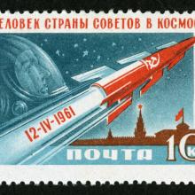 Russian ten-kopek stamp commemorating the first human spaceflight accomplished by Yuri Gagarin. The stamp features a depiction of a red rocket soaring above a Kremlin building, with a depiction of Gagarin in the sky.