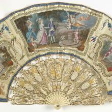 Ornate, ivory decorative fan with depictions of people watching air balloon launches.