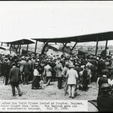 A large group of people view two Douglas World Cruisers, aircraft which were the first to travel around the world, in England.