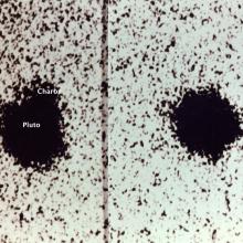 Telescopic view of Pluto and one of its moons, Charon. This was taken at the first discovery of Charon, which is visible as a tiny dot with its name labeled under the view.