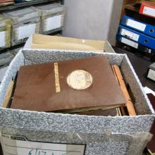 Open box of various items belonging to author Arthur C. Clarke.