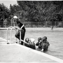 Female pilots-in-training in the process of exiting a swimming pool following a swimming lesson.