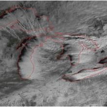 Satellite image of snowfall around the Great Lakes region of the United States and Canada.