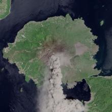 Satellite view of Sakura-jima, a volcano in Japan, during an eruption. Plumes of smoke are in the atmosphere above the volcano.