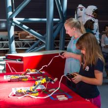 Two museum visitors participate in a robot activity as part of an astronaut game at the Museum's Steven F. Udvar-Hazy Center.