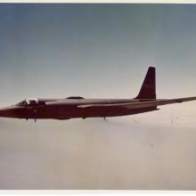 Side view of a jet aircraft with long wings. Aircraft is in flight.