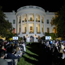 View of the White House exterior during an astronomy event held there. President Obama is speaking to a group of people.