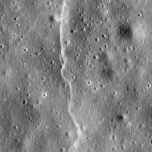 A line-shaped cliff feature is visible on a section of the Moon.