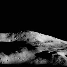 A tall mountain summit on one of the Moon's polar regions that receives some sunlight due to its impressive height.