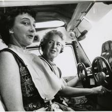 Two women, pilot Edna Whyte and her student, Martha Wright, sit in the cockpit of an aircraft during an air race.