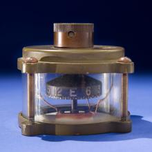 Metal and glass case containing full-rotating compass device.