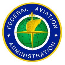 Federal logo featuring a blue and yellow circle surrounding a green globe with the compass arrow and a wing on the center. "Federal Aviation Administration" is stated in the blue and yellow circle in white.