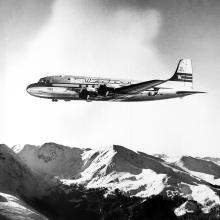 Side view of commercial aircraft in flight. Aircraft features Western Airlines livery.