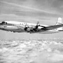 Side view of commercial aircraft in flight. Aircraft features four engines and Pan American Airways livery.