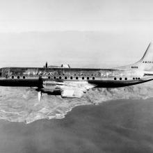 View of two-engine commercial aircraft in flight. Aircraft features American Airlines livery.