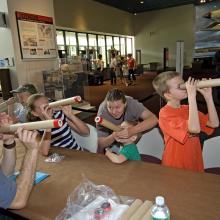 Visitors Look Through Telescopes at Explore the Universe Day