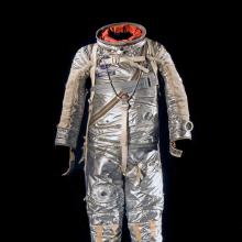 Silver-coated, full-body flight suit with various spots for tubes to be placed. 