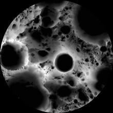 Map intended to illuminate the South Pole of the Moon. Multiple large dark spots are visible.