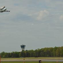 The Space Shuttle Discovery, attached to an aircraft modified for transporting shuttles, flies above Washington-Dulles airport prior to landing.