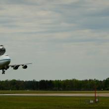 Space Shuttle Discovery, attached to an aircraft modified for shuttle transport, lands at Washington Dulles International Airport.