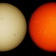 Two images of the sun using different telescopes but taken during the same day. The left image provides a yellow-colored disk with multiple sunspot clusters visible. The second image features a red-orange disk with multiple sunspots and prominences above the chromosphere.