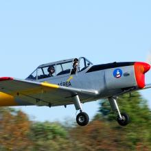 Side view of a silver and yellow aircraft with one propellor attached to the nose.