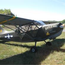 Side view of gray-colored monoplane with name "Gayle Ann" written on the side of the nose. A star is painted behind the cockpit and registration number 298758 is painted in yellow on the vertical stabilizer.