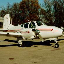 Side view of white monoplane with twin engines. 