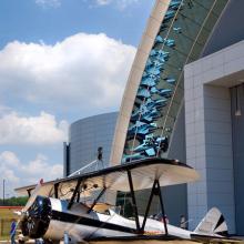 Side view of white and black biplane with single engine.