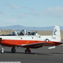 Side view of white and reddish-brown monoplane with one engine.