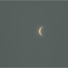 View of Venus as a waxing crescent in the sky.