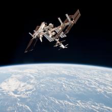 The Space Shuttle Endeavour is docked onto the International Space Station above Earth.