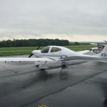 Side view of white monoplane with one engine. The registration number "N946DS" is painted on the vertical stabilizer and fin.