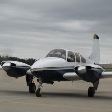 Front view of white and dark blue monoplane with twin engines.