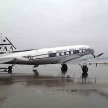 Side view of white and black commercial aircraft with two engines and Pan-American World Airways livery.