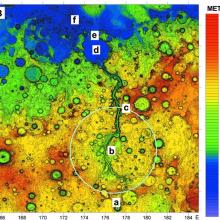 Colored topographical map of an area of Mars featuring a large outflow channel of scoured land.