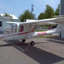 Side view of white monoplane with red accents and a single engine. The registration number N439S4 is painted in red between the fuselage and the vertical stabilizer.