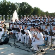 United States Public Health Service Music Ensemble, a large group of musicians, performs in a concert.