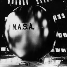 View of a large, mylar balloon with the branding of "N.A.S.A." in large, dark letters in the center of the visible balloon.